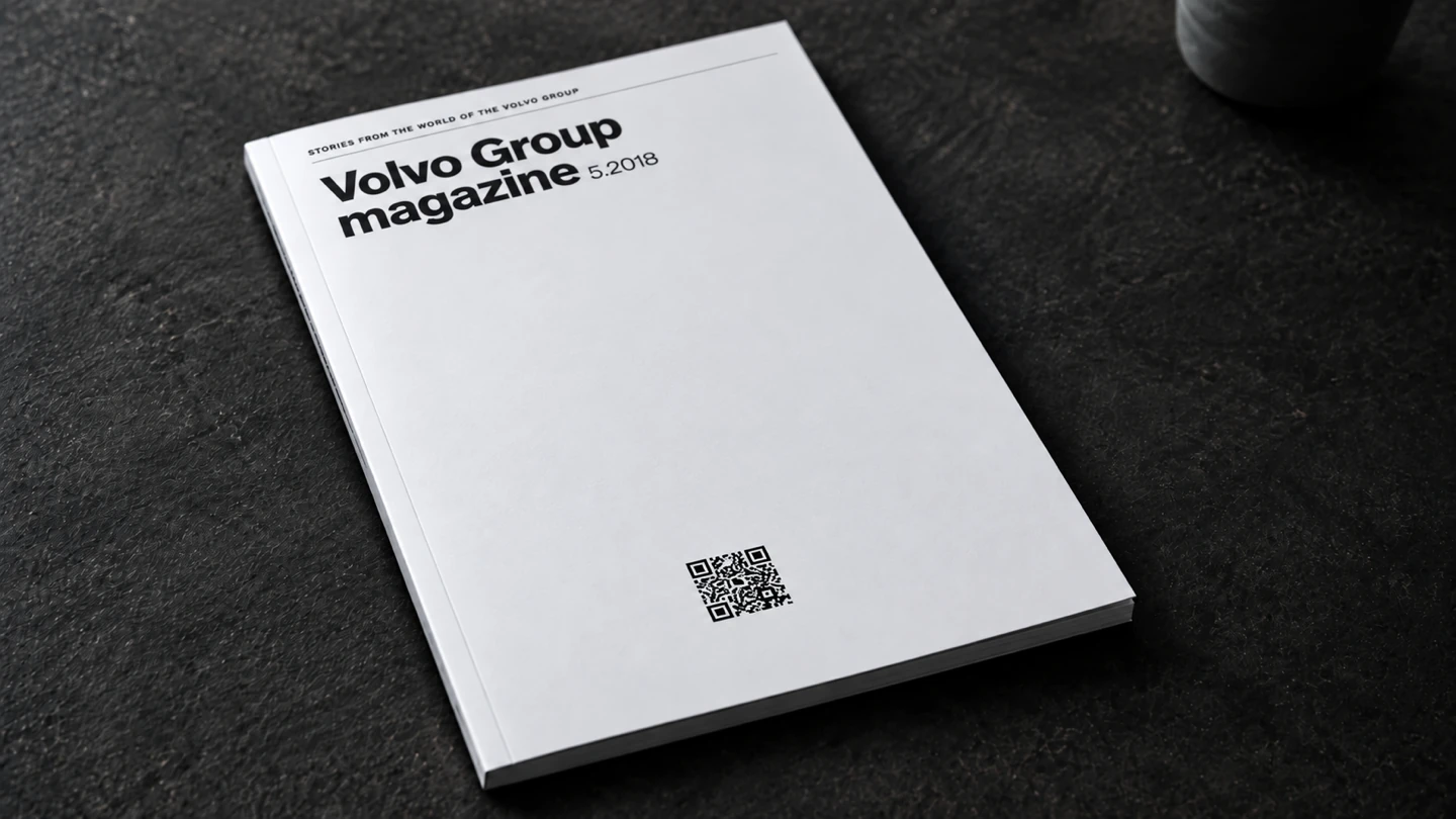 A clean white Volvo Group Magazine cover with its masthead and a small QR code