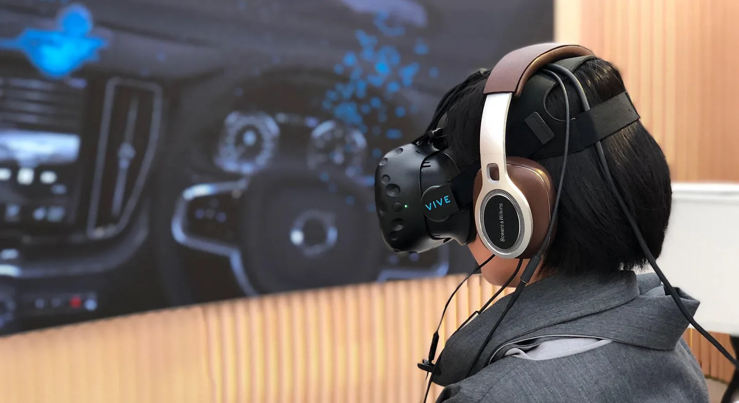 A visitor wearing a Vive headset inside a Volvo Studio Store